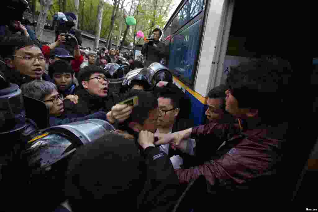 South Korean police officers attempt to detain a protester during a May Day rally in central Seoul, May 1, 2013. 