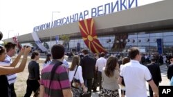 FILE - Visitors arrive at Alexander the Great Airport, near Macedonia's capital, Skopje, Sept 6, 2011.