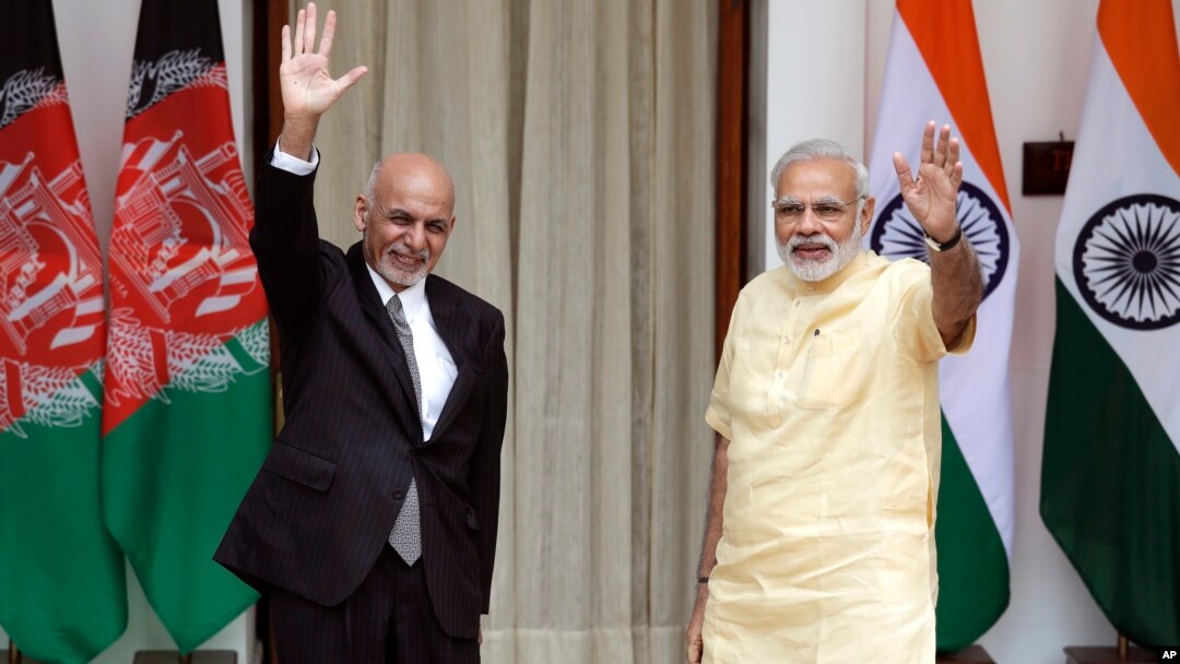 Indian Prime Minister Narendra Modi, right, and Afghan President Ashraf Ghani wave at the media before a meeting in New Delhi, India, Sept. 14, 2016. President Ghani is on a two-day visit to India.