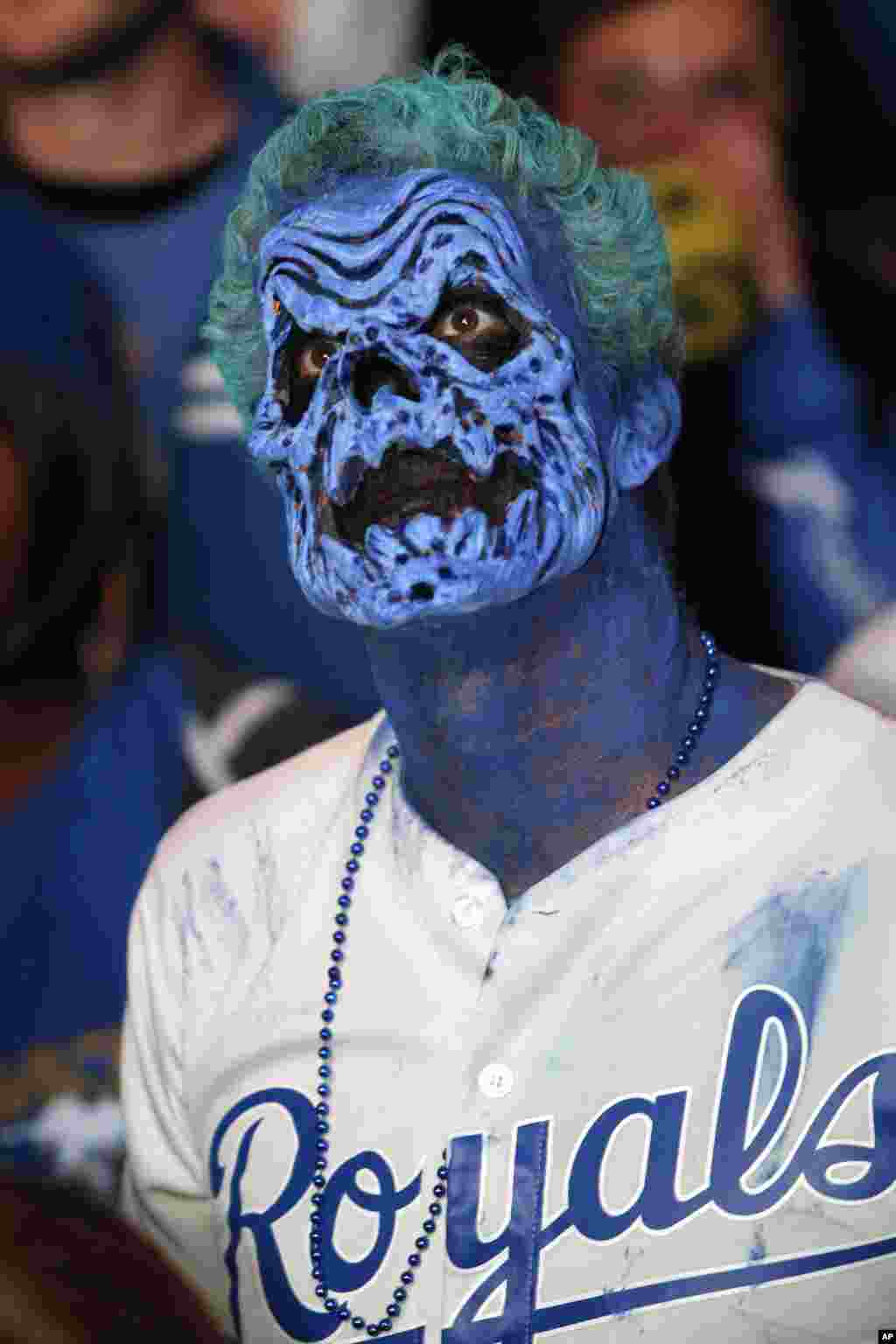 Dressed for Halloween, a Kansas City Royals fan watches Game 7 of the World Series in the Power and Light entertainment district in Kansas City, Missouri, Oct. 29, 2014. 