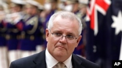 FILE - Australian Prime Minister Scott Morrison is pictured in Tokyo, Nov. 17, 2020. Morrison said Nov. 30, 2020, that a tweet by a Chinese official showing a fake image of an Australian soldier appearing to slit a child's throat was “truly repugnant." 