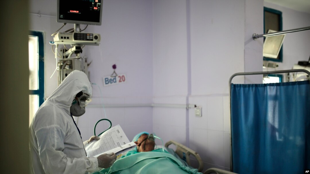 File - A medical worker wearing personal protective equipment takes care of a COVID-19 patient in an intensive care unit at a hospital in Sanaa, Yemen, June 14, 2020. 