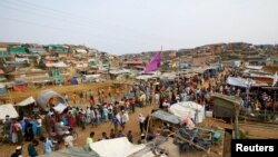 FILE - Rohingya refugees gather at a market inside a refugee camp in Cox's Bazar, Bangladesh, March 7, 2019. 