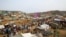 FILE - Rohingya refugees gather at a market inside a refugee camp in Cox's Bazar, Bangladesh, March 7, 2019. 