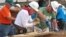Former President Jimmy Carter, center, works on a Habitat for Humanity construction project in Memphis, Tennessee, Aug. 22, 2016.