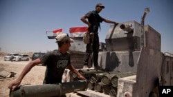 Iraqi counterterrorism forces load a Humvee with rockets to take to a front line position in their fight to oust Islamic State militants from Fallujah, Iraq, June 7, 2016.