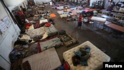 African and Haitian migrants intending to seek asylum in the U.S. rest on mattresses inside a shelter in Mexicali, Mexico, Oct. 5, 2016. 