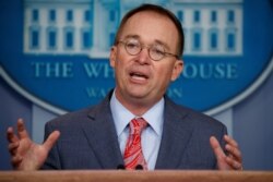 FILE - White House Chief of Staff Mick Mulvaney speaks to reporters in Washington, Oct. 17, 2019.