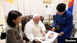 Pope Francis looks at pictures as he meets with Mongolia's Foreign Minister Batmunkh Battsetseg during his apostolic journey in Ulaanbaatar, Mongolia September 4, 2023. 