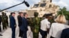 Commander Godfrey Otunge of the Multinational Security Support Mission, third from right, shows U.S. Secretary of State Antony Blinken, fourth from right, vehicles from the U.S. government in Port-au-Prince, Haiti, Sept. 5, 2024. (Roberto Schmidt/Pool photo via AP)