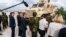 Commander Godfrey Otunge of the Multinational Security Support Mission, third from right, shows U.S. Secretary of State Antony Blinken, fourth from right, vehicles from the U.S. government in Port-au-Prince, Haiti, Sept. 5, 2024. (Roberto Schmidt/Pool photo via AP)