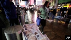 FILE - Bundles of the New York Post are stacked for distribution in front of Penn Station, Nov. 27, 2013, in New York.
