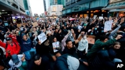 Demonstrators hold placards during a march in central Auckland, New Zealand, June 1. 2020, to protest the death of United States' George Floyd, a black man who died in police custody.