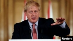 British Prime Minister Boris Johnson holds a news conference addressing the government's response to the coronavirus outbreak, at Downing Street in London, March 12, 2020. 