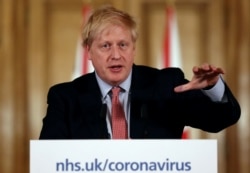 FILE - British Prime Minister Boris Johnson holds a news conference addressing the government's response to the coronavirus outbreak, at Downing Street in London, March 12, 2020.