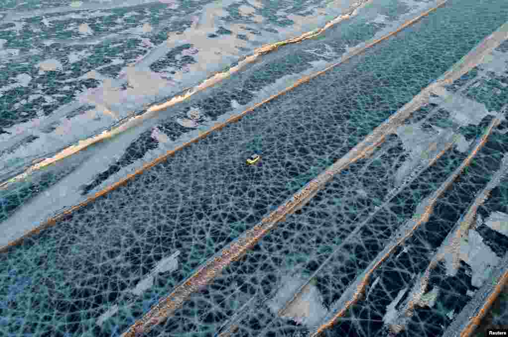 A car drives along a five-kilometer-long road, which is supervised by regional traffic services to connect the banks of the ice-covered Yenisei River during winter season, south of Krasnoyarsk, Russia, March 3, 2019.