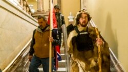 Supporters of President Donald Trump walk down the stairs outside the Senate Chamber as violence erupted at the Capitol following a breach of security, Jan. 6, 2021, in Washington.