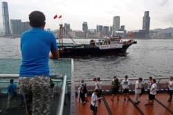 A vessel displaying a banner saying "Cherish Hong Kong, Stay Together" passes Victoria Harbor during a pro-government rally in Hong Kong, July 20, 2019.