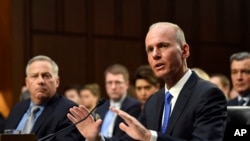 Boeing Company President and Chief Executive Officer Dennis Muilenburg, right, sitting next to Boeing Commercial Airplanes Vice President and Chief Engineer John Hamilton, left, testifies on Capitol Hill in Washington, Oct. 29, 2019.