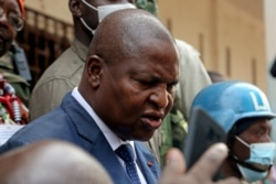 FILE - Central African Republic President Faustin-Archange Touadera addresses the media outside a polling station, after casting his ballots during the presidential and legislative elections at a polling station in Bangui, Dec. 27, 2020.