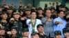 Philippines President Rodrigo Duterte (C) clenches fist with members of the Philippine Army during his visit at the army headquarters in Taguig city, metro Manila, Philippines October 4, 2016. (REUTERS/Romeo Ranoco)