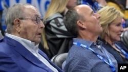 FILE - Orlando Magic owner Rich DeVos (L), his son, Amway president Doug DeVos (C), and daughter-in-law, Maria DeVos, watch from their court side seats during the first half of an NBA basketball game against the Houston Rockets Jan. 3, 2018, in Orlando, FLA.