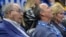 FILE - Orlando Magic owner Rich DeVos (L), his son, Amway president Doug DeVos (C), and daughter-in-law, Maria DeVos, watch from their court side seats during the first half of an NBA basketball game against the Houston Rockets Jan. 3, 2018, in Orlando, FLA.