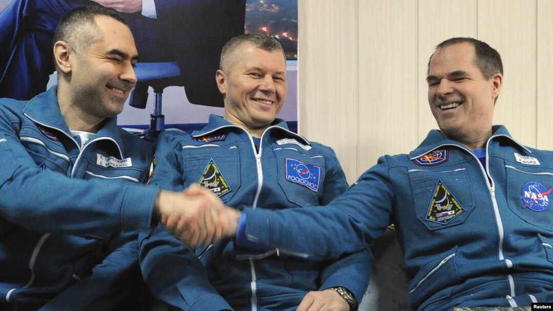 International Space Station (ISS) crew members Russian cosmonauts Evgeny Tarelkin (L) and Oleg Novitskiy (C) and U.S. astronaut Kevin Ford sit together at Kustanay Airport after they landed near the town of Arkalyk, March 16, 2013. 