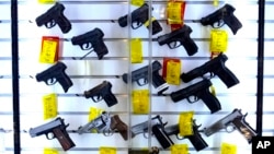 FILE - A selection of handguns are displayed at the Kittery Trading Post, Aug. 9, 2024, in Kittery, Maine. 