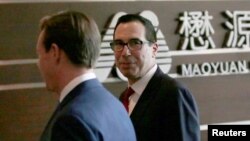 U.S. Treasury Secretary Steven Mnuchin, right, and a U.S. delegation arrive at a hotel in Beijing for trade talks with China, May 3, 2018.