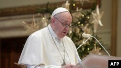 This handout photo taken on December 25, 2020, and released by the Vatican press office, the Vatican Media, shows Pope Francis delivering his live-streamed Urbi et Orbi blessing from the Vatican Blessing hall. (Photo by Handout / VATICAN MEDIA / AFP…