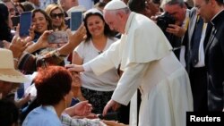 Pope Francis greets a child as he arrives to lead the Marian celebration of the Virgin de la Puerta in Trujillo, Peru, Jan. 20, 2018. 