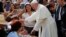 Pope Francis greets a child as he arrives to lead the Marian celebration of the Virgin de la Puerta in Trujillo, Peru, Jan. 20, 2018. 