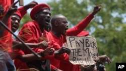 Members of the Economic Freedom Fighters protest outside the Constitutional Court in Johannesburg, Tuesday, Feb. 9, 2016.