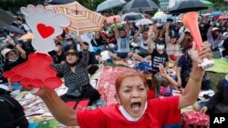 FILE - Pro-democracy activists shout slogans during a protest at Thammasat University in Bangkok, Thailand, Sept. 19, 2020. Demonstrators are calling for a new election and democratic reforms.