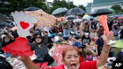 FILE - Pro-democracy activists shout slogans during a protest at Thammasat University in Bangkok, Thailand, Sept. 19, 2020. Demonstrators are calling for a new election and democratic reforms.