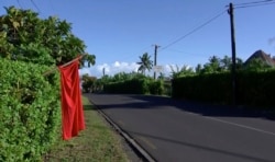 A red flag hangs outside the home of residents who have not been vaccinated in Apia, Samoa, Dec. 5, 2019. Samoa’s main streets were quiet Thursday, as the government stepped up efforts to curb a measles epidemic that has killed 62 people.