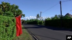A red flag hangs outside the home of residents who have not been vaccinated in Apia, Samoa, Dec. 5, 2019.
