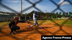 Baseball players play with friends at a field in Havana, Oct. 7, 2021. This year a record number of Cuban baseball players have defected abroad.