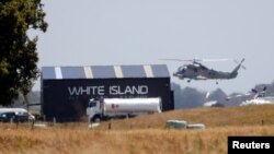 A military helicopter flies at the airport during the rescue mission following the White Island volcano eruptions in Whakatane, New Zealand, Dec. 13, 2019. 