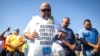 Longshoremen bow for a prayer during a strike at the Bayport Container Terminal, Oct. 1, 2024, in Houston.