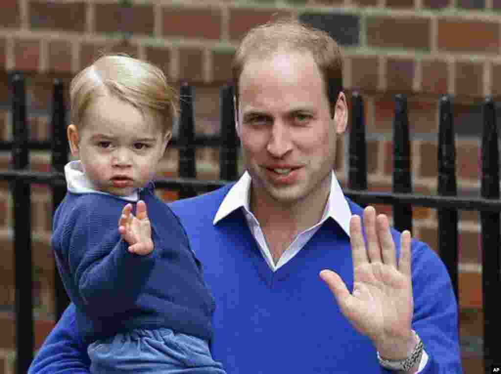 Britain's Prince William and his son Prince George wave as they return to St. Mary's Hospital's exclusive Lindo Wing, London, Saturday, May 2, 2015. William's wife, Kate, the Duchess of Cambridge, gave birth to a baby girl on Saturday morning. (AP Photo/