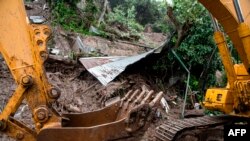 A bulldozer removes debris during the search for seven people who were buried by a landslide due to the heavy rains caused by Tropical Storm Cristobal, in Santo Tomas, southern San Salvador, on June 4, 2020.