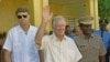 (FILES) Former US President Jimmy Carter (C) waves after meeting 22 September 1990 in Port-au-Prince with authorities about the upcoming elections in Haiti.