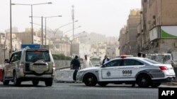 Polisi Kuwait berjaga di pos pemeriksaan sebuah pintu masuk kota Jeleeb Al-Shuyoukh, selatan Kuwait City, 7 April 2020 saat diberlakukannya karantina di kawasan tersebut akibat pandemi corona. (Foto: dok).