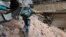A child navigates rubble and barbed wire in Aleppo, Syria, Feb. 11, 2016.