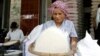 A Cambodian vendor cleans rice at her shop in a roadside market in Phnom Penh, Cambodia. (AP Photo/Heng Sinith)