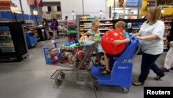 FILE - A family shops at a Wal-Mart Supercenter store in Springdale, Arkansas, June 4, 2015.