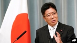 FILE - Japanese Health Minister Katsunobu Kato speaks during a press conference at the prime minister's official residence in Tokyo, Sept. 11, 2019. 