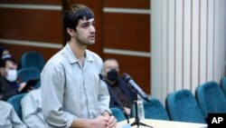 In this photo released by Mizan News Agency, Mohammad Mehdi Karami, a protester convicted and executed, speaks during his trial at the Revolutionary Court, in the city of Karaj, Iran, on Nov. 30, 2022. Iran said it executed Karami on Jan. 7, 2023.
